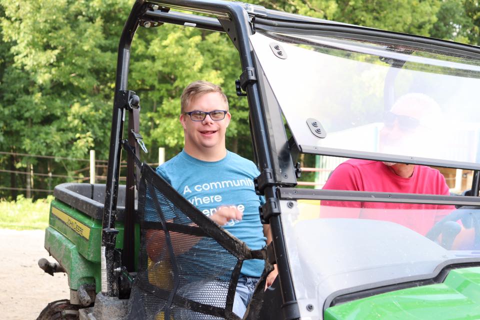 Image shows individual smile and riding in an All Terrain Vehicle